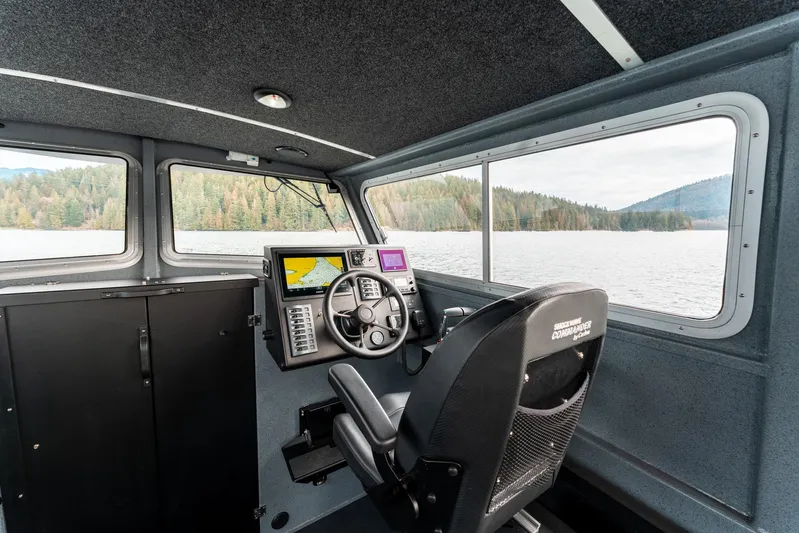  Yacht Photos Pics Interior of 2023 Liquid Metal Marine Maquinna Crew boat with navigation equipment and scenic lake view.