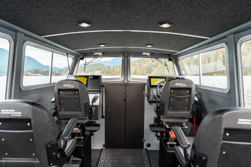  Yacht Photos Pics Interior of 2023 Liquid Metal Marine Maquinna Crew boat with modern seating and navigation equipment.