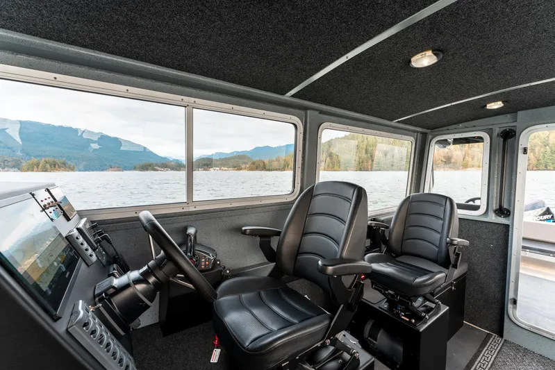  Yacht Photos Pics Interior of 2023 Liquid Metal Marine Maquinna Crew boat with two black captain chairs.