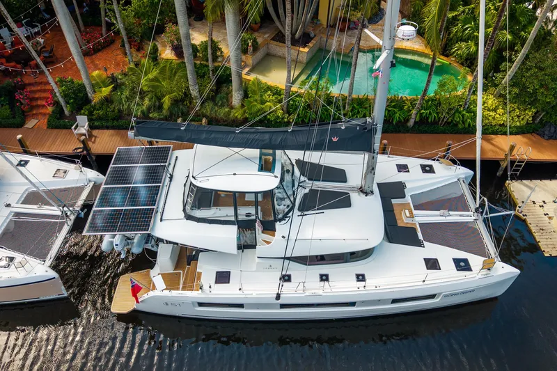 Going Deeper Yacht Photos Pics 2024 Lagoon 51 catamaran docked, featuring solar panels and luxurious design.