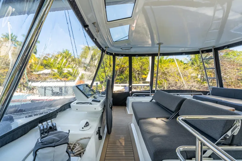 Going Deeper Yacht Photos Pics Interior view of 2024 Lagoon 51 yacht with modern seating and navigation equipment.