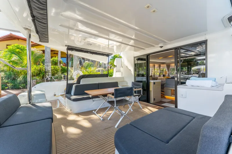 Going Deeper Yacht Photos Pics Luxurious 2024 Lagoon 51 yacht interior with modern seating and dining area.