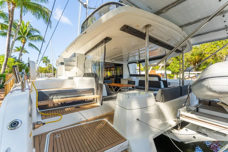 Going Deeper Yacht Photos Pics 2024 Lagoon 51 yacht deck with modern seating and tropical backdrop.