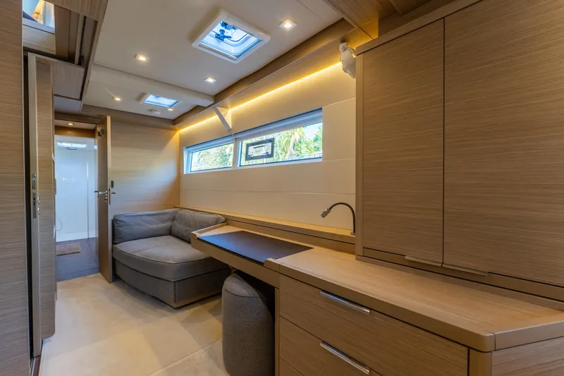 Going Deeper Yacht Photos Pics Luxurious interior of 2024 Lagoon 51 yacht with modern wood finishes and cozy seating area.