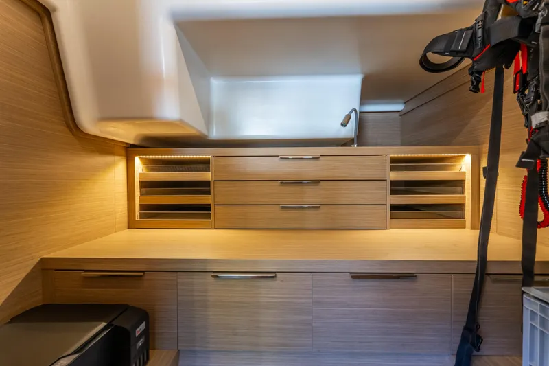 Going Deeper Yacht Photos Pics Modern interior of 2024 Lagoon 51 yacht with sleek wooden cabinetry and ambient lighting.
