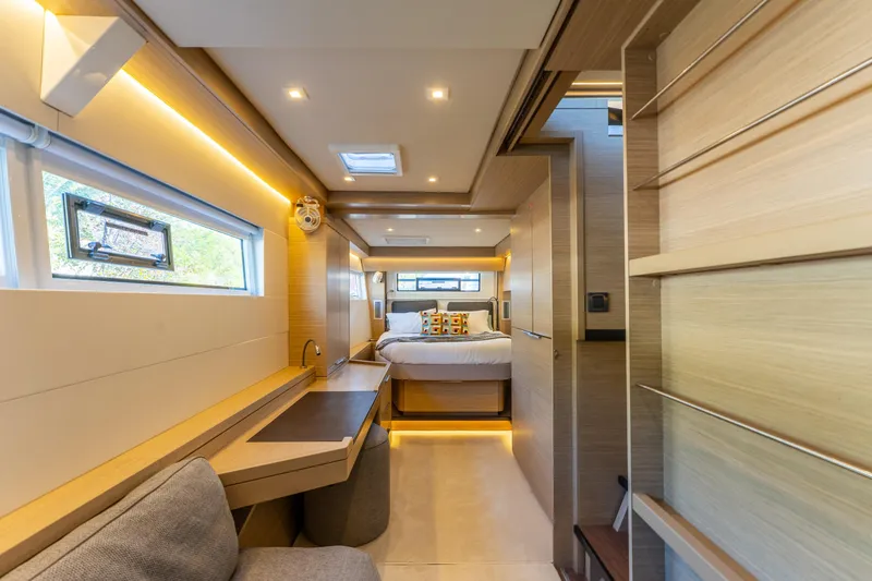 Going Deeper Yacht Photos Pics Luxurious interior of 2024 Lagoon 51 yacht with modern design and cozy bedroom.