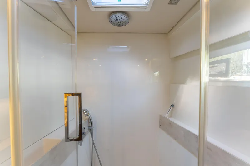 Going Deeper Yacht Photos Pics Modern shower interior in 2024 Lagoon 51 yacht, featuring sleek design and glass door.