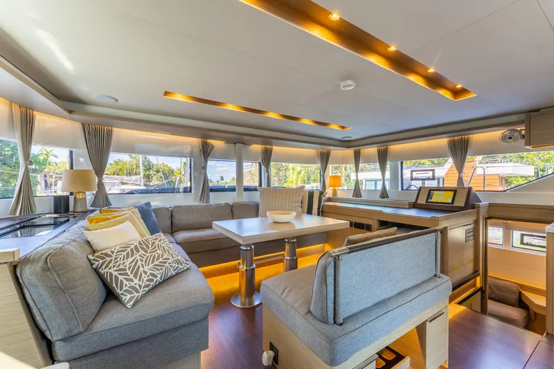 Going Deeper Yacht Photos Pics Luxurious interior of 2024 Lagoon 51 yacht with modern furnishings and panoramic windows.