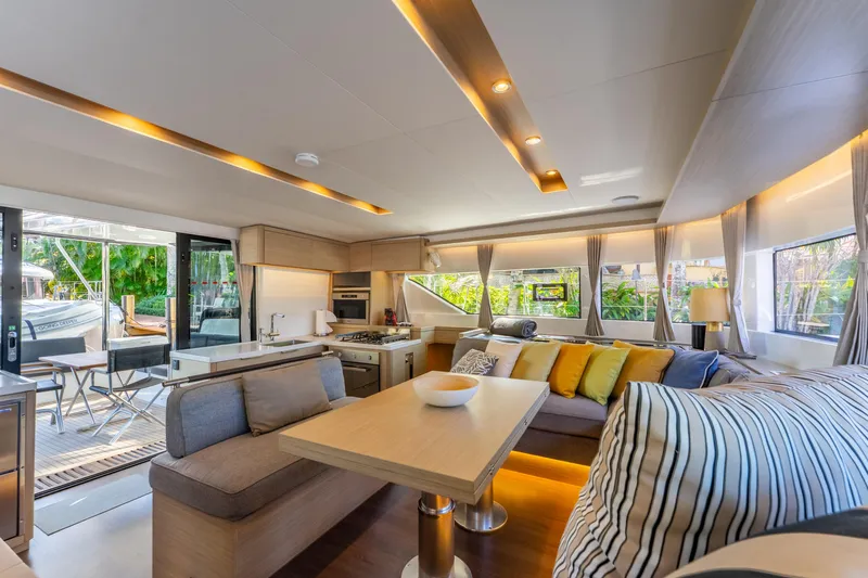Going Deeper Yacht Photos Pics Luxurious interior of 2024 Lagoon 51 yacht with modern kitchen and cozy seating area.
