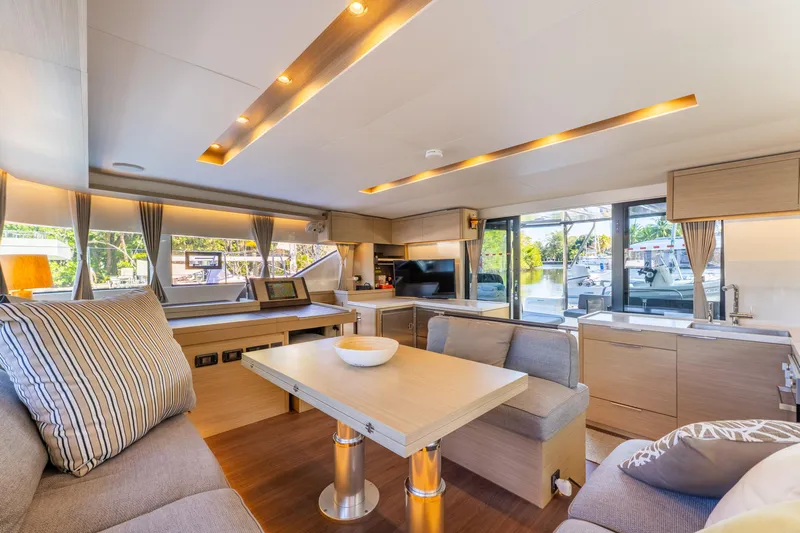 Going Deeper Yacht Photos Pics Luxurious interior of 2024 Lagoon 51 yacht with modern furnishings and ample natural light.