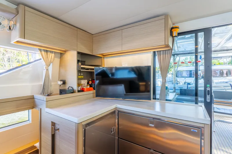 Going Deeper Yacht Photos Pics Modern interior of 2024 Lagoon 51 yacht with sleek kitchen and large windows.