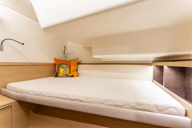 Going Deeper Yacht Photos Pics 2024 Lagoon 51 yacht cabin with modern design and colorful pillow.