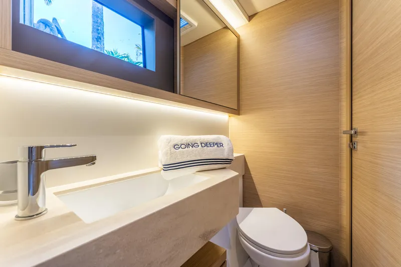 Going Deeper Yacht Photos Pics Luxurious bathroom in 2024 Lagoon 51 yacht with modern fixtures and elegant design.