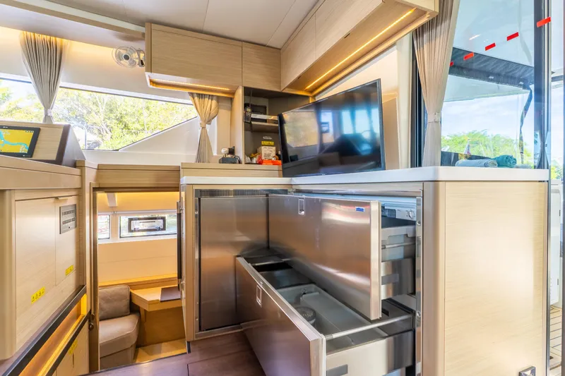 Going Deeper Yacht Photos Pics Luxurious interior of 2024 Lagoon 51 yacht with modern kitchen and entertainment area.