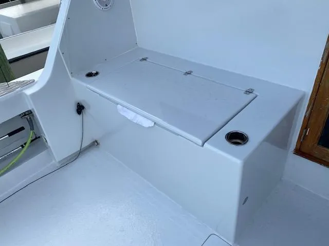 Cost Of Living Yacht Photos Pics 1985 Bertram 38 Convertible boat interior with storage compartment and cup holders.