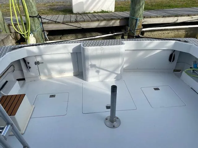 Cost Of Living Yacht Photos Pics 1985 Bertram 38 Convertible boat deck, spacious and clean, docked at marina.