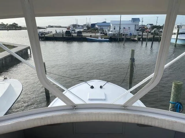 Cost Of Living Yacht Photos Pics 1985 Bertram 38 Convertible yacht docked at a marina, view from the helm.