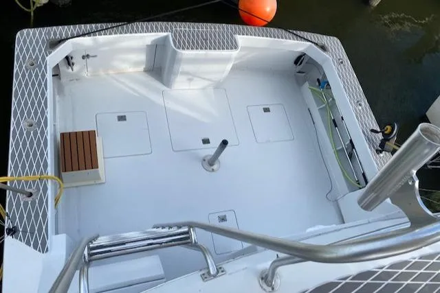 Cost Of Living Yacht Photos Pics 1985 Bertram 38 Convertible boat deck with clean, spacious layout and railing.