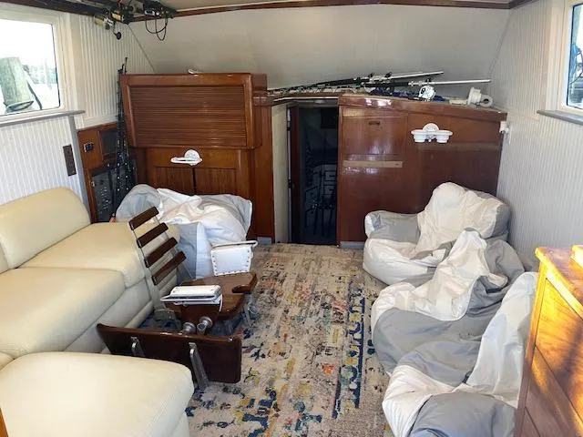 Cost Of Living Yacht Photos Pics Interior of 1985 Bertram 38 Convertible yacht with cozy seating and fishing gear.