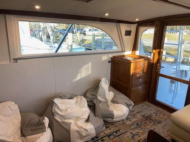 Cost Of Living Yacht Photos Pics Interior of 1985 Bertram 38 Convertible yacht with bean bags and wooden cabinet.