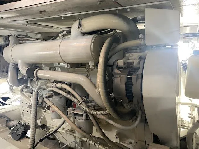 Cost Of Living Yacht Photos Pics Engine of a 1985 Bertram 38 Convertible boat, showcasing intricate mechanical components.