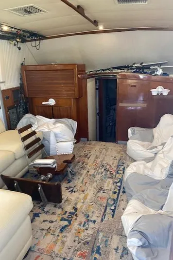 Cost Of Living Yacht Photos Pics Interior of 1985 Bertram 38 Convertible yacht with cozy seating and nautical decor.