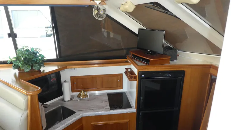  Yacht Photos Pics Interior of 1995 Riviera Convertible yacht with kitchenette, TV, and modern amenities.