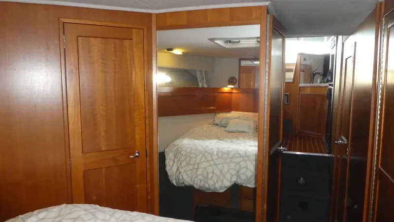  Yacht Photos Pics 1995 Riviera Convertible interior with wooden cabinetry and cozy bedroom.