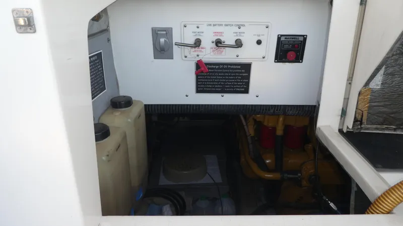  Yacht Photos Pics Engine compartment of a 1995 Riviera Convertible with battery switch controls and oil containers.