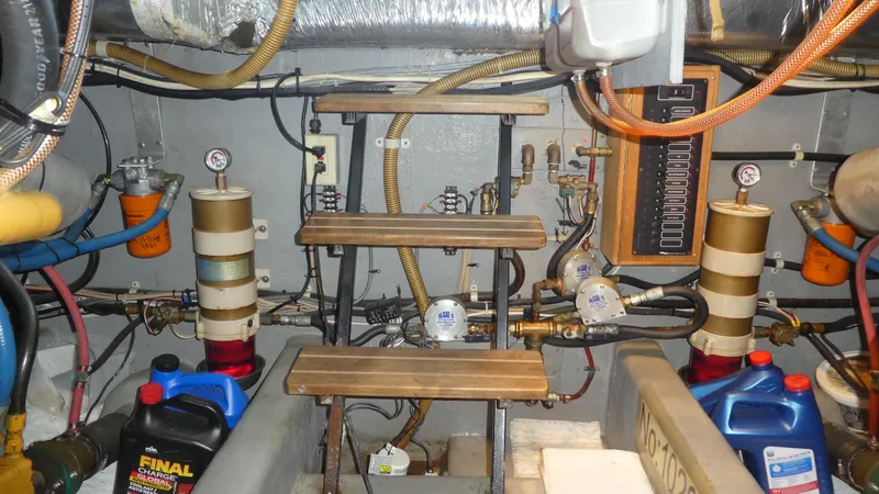  Yacht Photos Pics Engine room of a 1995 Riviera Convertible with gauges, pipes, and maintenance supplies.