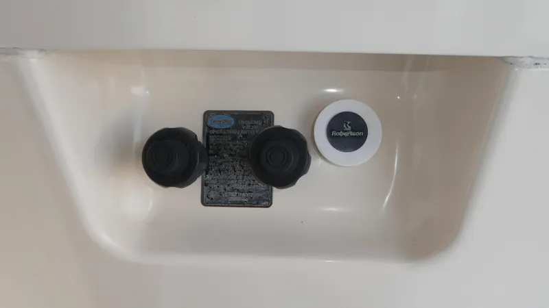  Yacht Photos Pics Control panel of a 1995 Riviera Convertible boat with knobs and Robertson label.