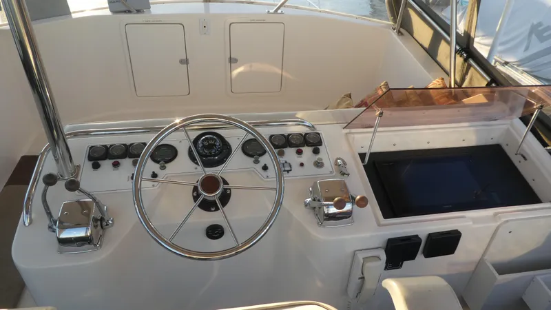  Yacht Photos Pics 1995 Riviera Convertible boat helm with steering wheel, gauges, and controls.