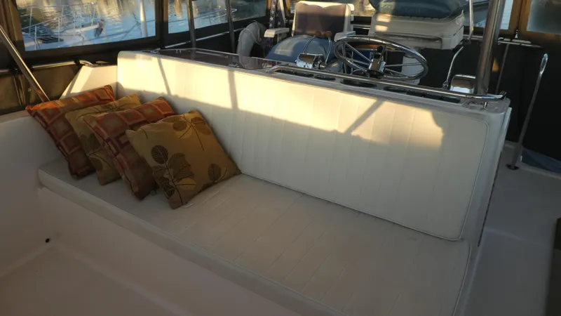  Yacht Photos Pics 1995 Riviera Convertible boat interior with cushioned seating and decorative pillows.