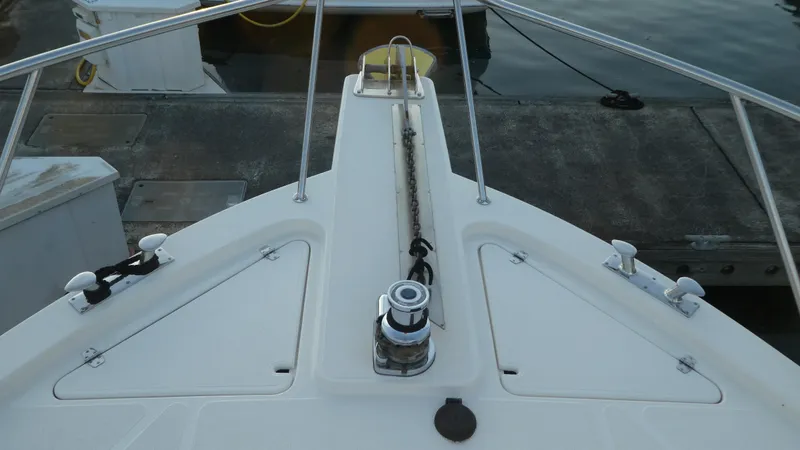  Yacht Photos Pics 1995 Riviera Convertible boat deck with anchor chain and railing at dock.