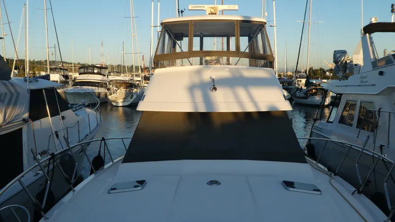  Yacht Photos Pics 1995 Riviera Convertible yacht docked in a marina at sunset.