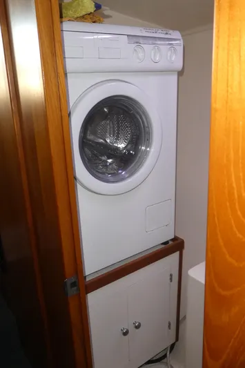  Yacht Photos Pics Washing machine in a compact wooden cabinet on a 1995 Riviera Convertible.
