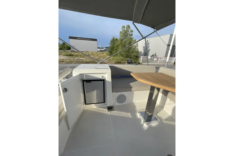  Yacht Photos Pics Interior of 2020 Prestige 420 yacht with seating, table, and mini fridge.