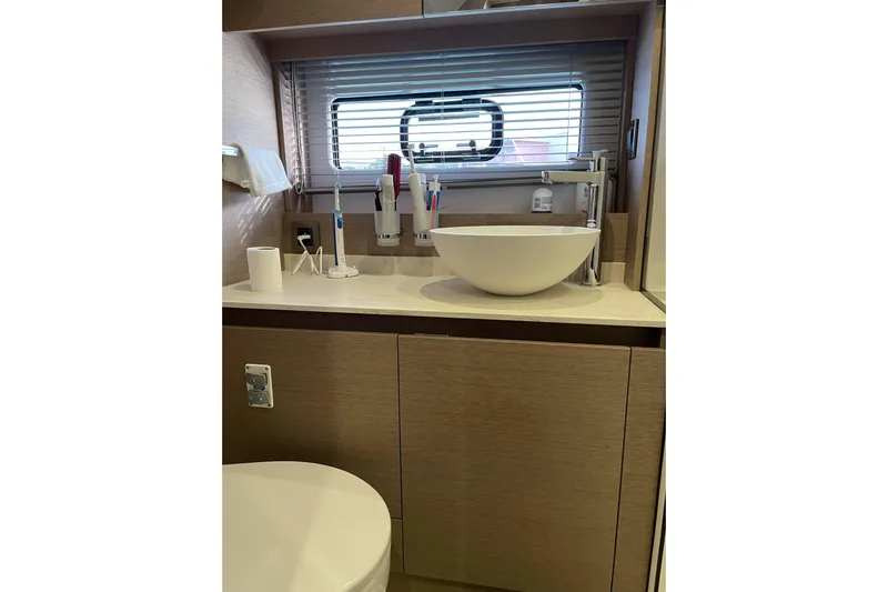 Yacht Photos Pics Modern bathroom interior on a 2020 Prestige 420 yacht, featuring a sleek sink and window.