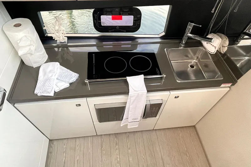  Yacht Photos Pics Modern kitchen in 2024 Sessa Marine F42 Flybridge yacht with stove and sink.