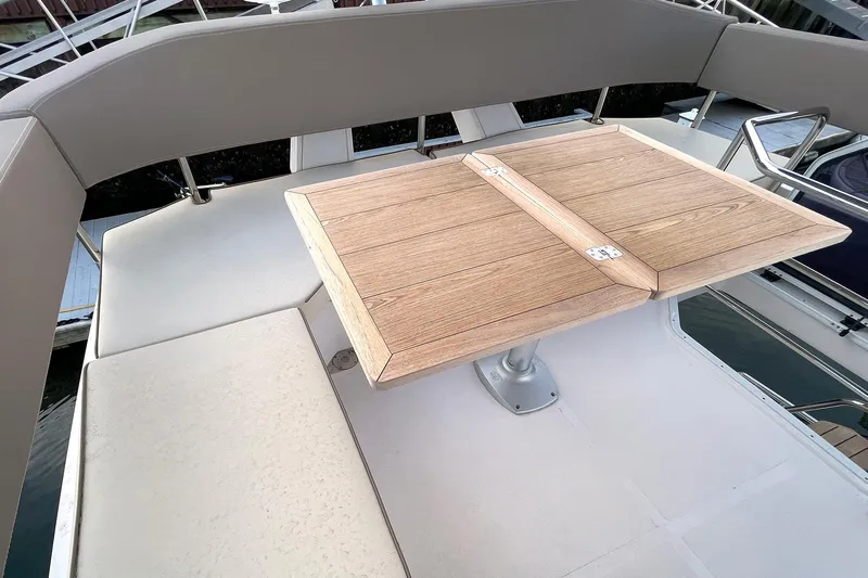  Yacht Photos Pics Flybridge seating area with wooden table on 2024 Sessa Marine F42 yacht.