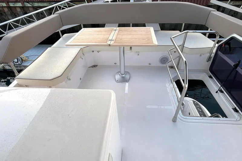  Yacht Photos Pics 2024 Sessa Marine F42 Flybridge with seating and table on deck.
