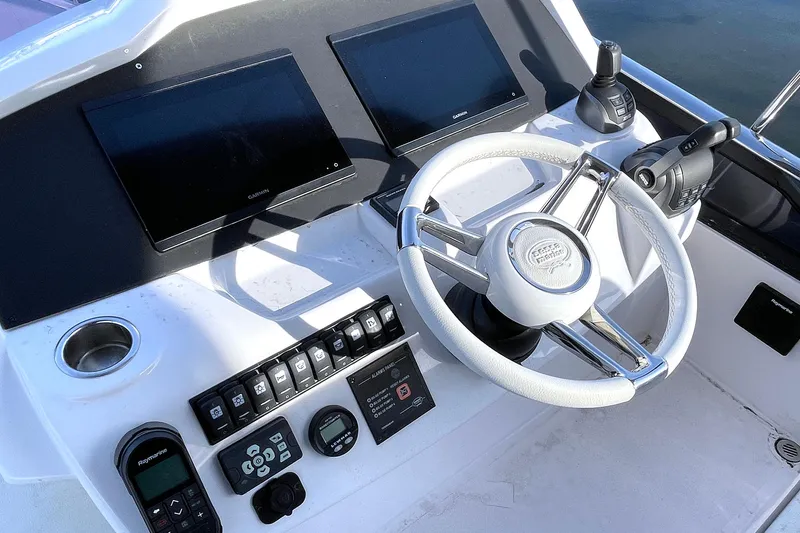  Yacht Photos Pics 2024 Sessa Marine F42 Flybridge helm with dual screens and modern controls.