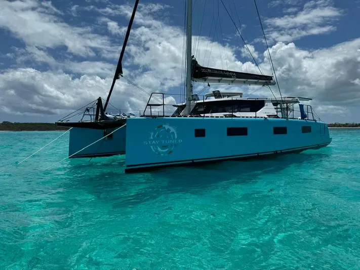 Vision 444es Yacht Photos Pics Vision 444 ES 2025 catamaran sailing on clear turquoise waters under a cloudy sky.