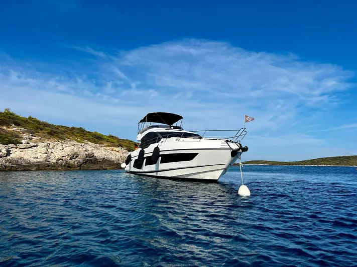  Yacht Photos Pics 2019 Sunseeker 74 Sport Yacht anchored in tranquil bay.
