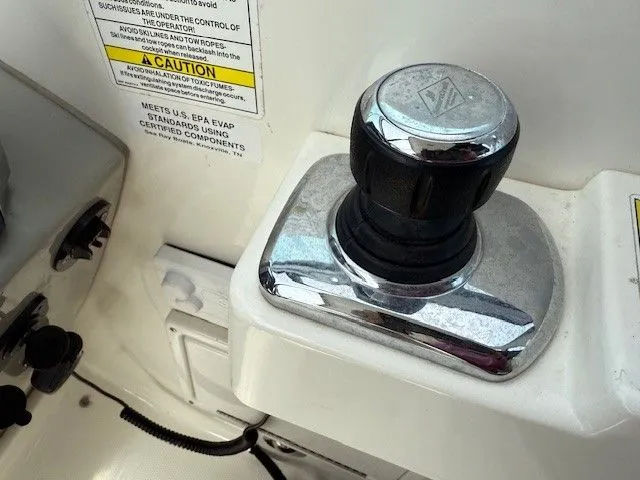 Bella Vida Yacht Photos Pics Close-up of a 2014 Sea Ray 310 Sundancer boat control knob and caution label.