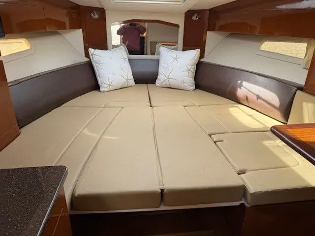 Bella Vida Yacht Photos Pics Interior cabin of 2014 Sea Ray 310 Sundancer with beige cushions and pillows.
