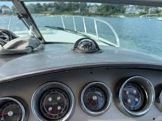 Bella Vida Yacht Photos Pics Dashboard view of 2014 Sea Ray 310 Sundancer boat with gauges and compass.