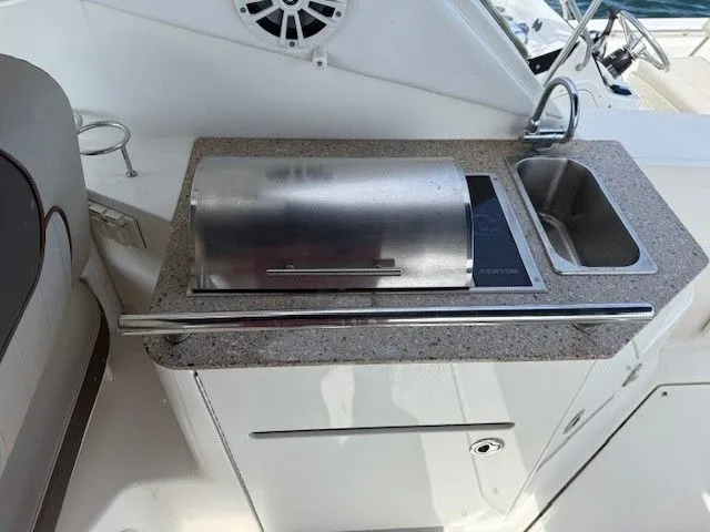 Bella Vida Yacht Photos Pics Outdoor kitchenette on 2014 Sea Ray 310 Sundancer yacht with grill and sink.