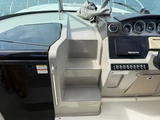 Bella Vida Yacht Photos Pics 2014 Sea Ray 310 Sundancer helm with steps and navigation controls.