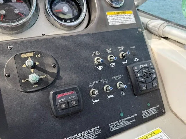 Bella Vida Yacht Photos Pics Control panel of a 2014 Sea Ray 310 Sundancer boat with various switches and gauges.